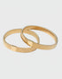Gilt armbands on a light gray background