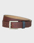 Brown leather belt with a silver buckle on a light gray background