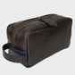 Brown leather toiletry bag with a blue interior on a light gray background