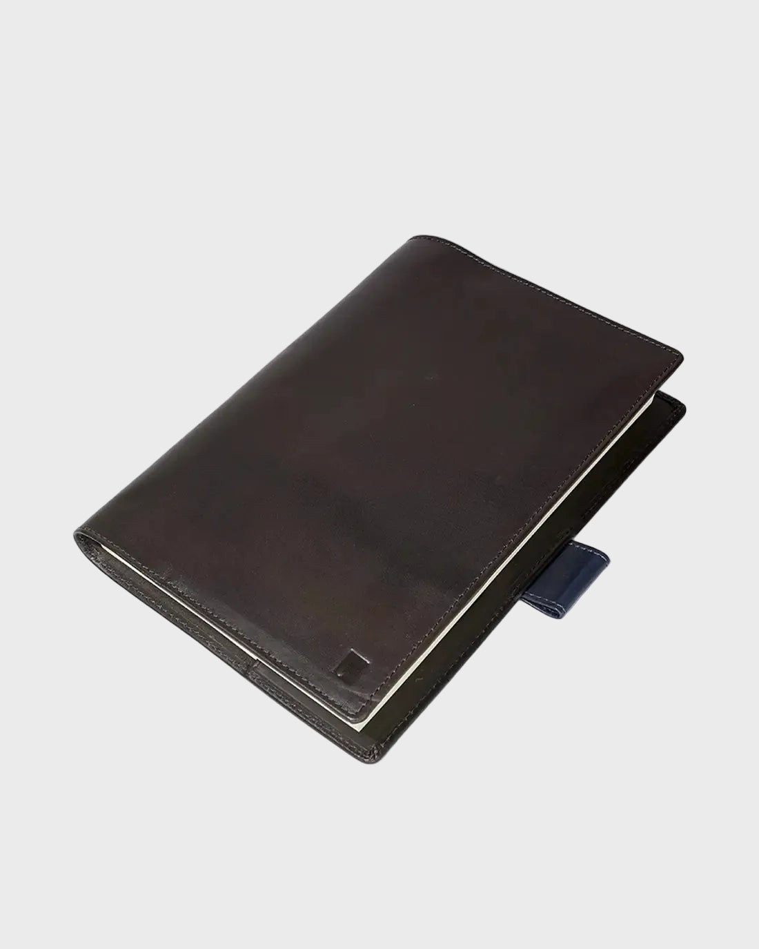 Dark brown leather notebook on a white background