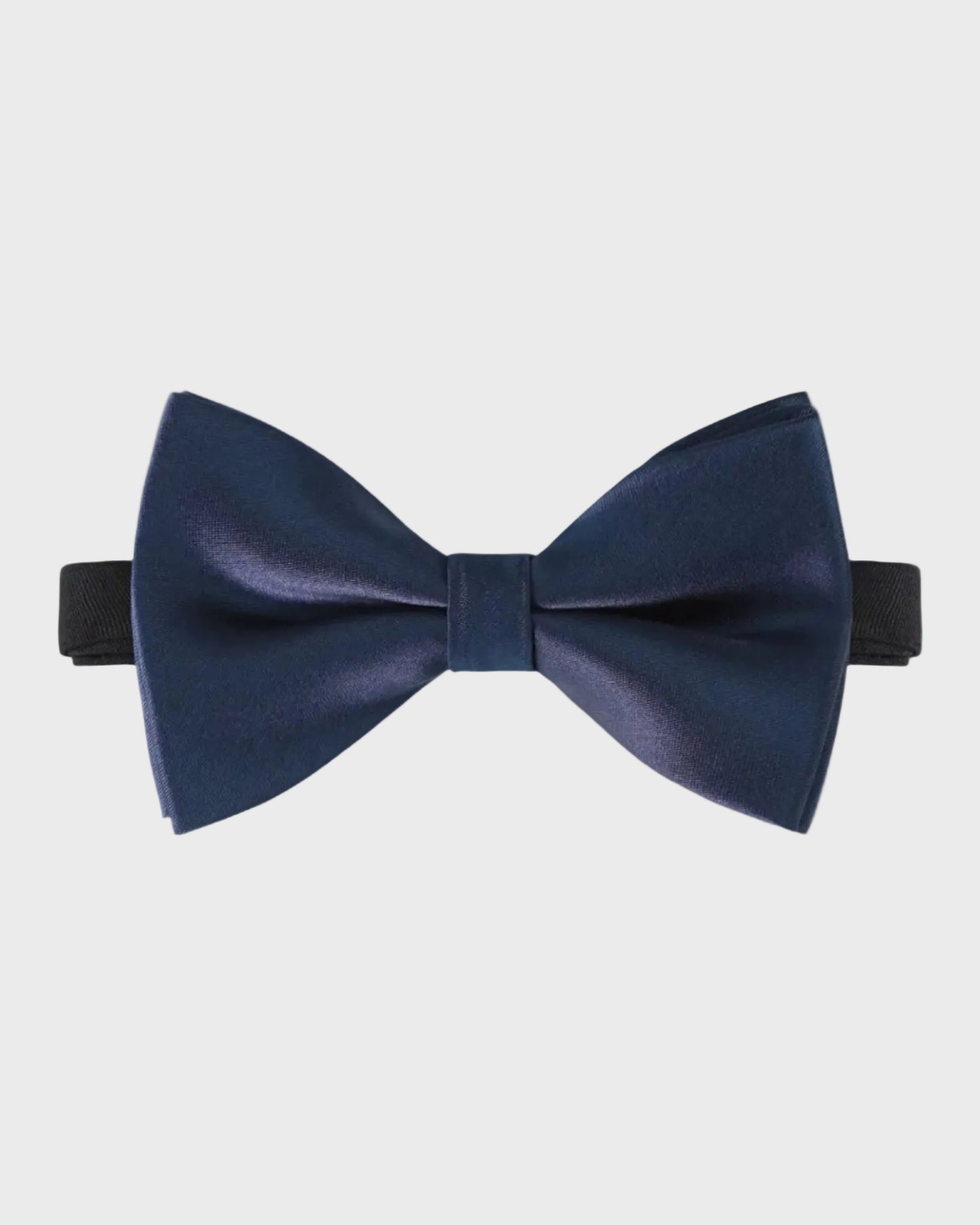 Navy blue bow tie on a light gray background