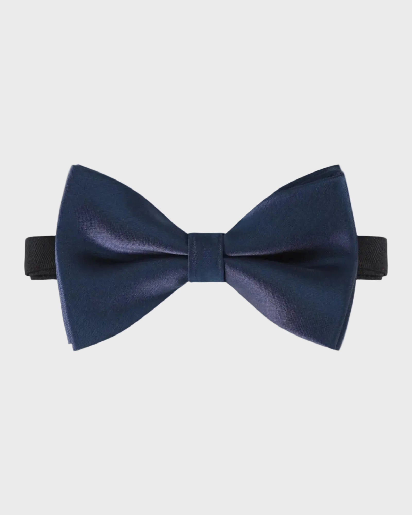 Navy blue bow tie on a light gray background