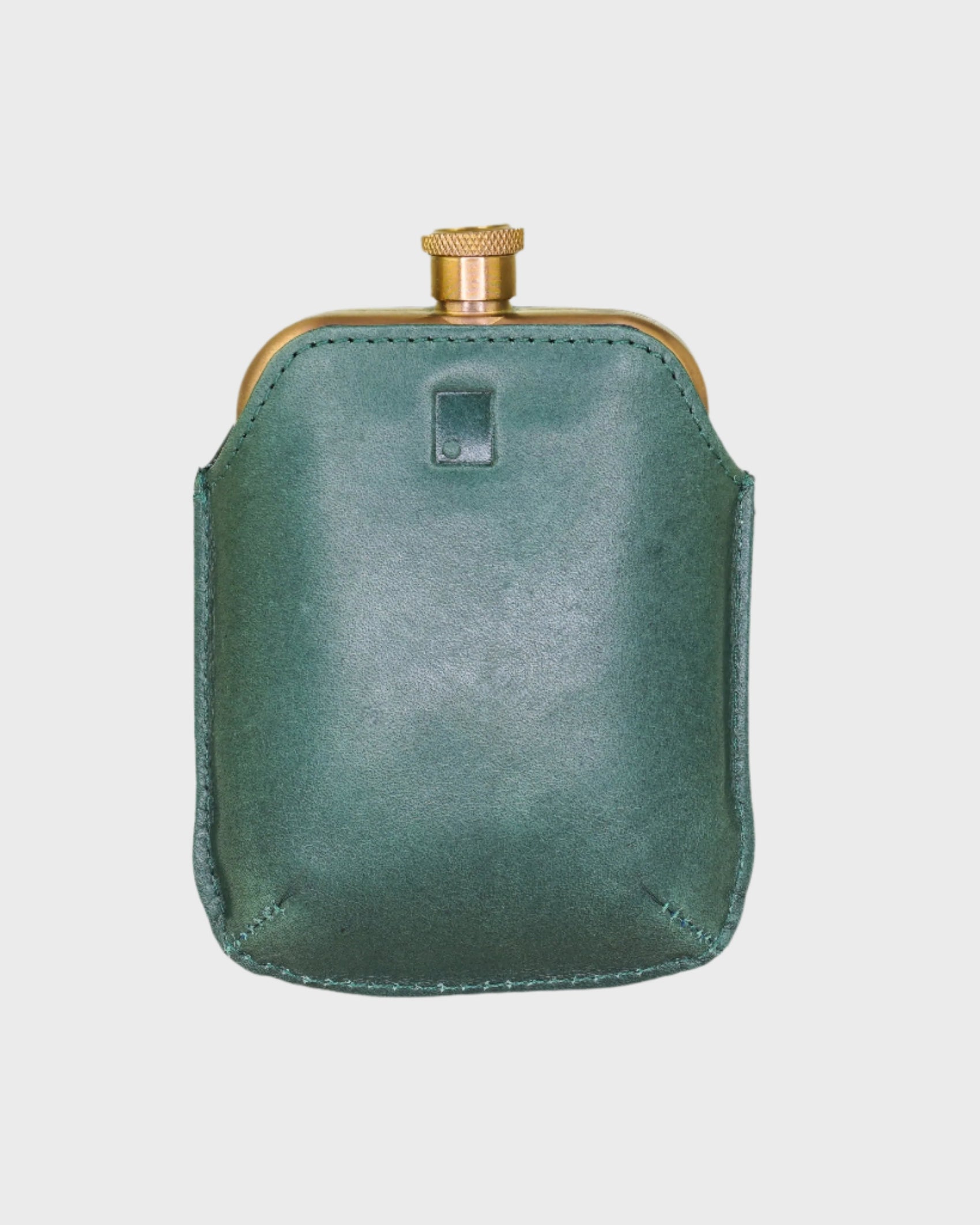 Green leather flask on a light gray background