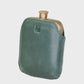 Green leather flask on a light gray background