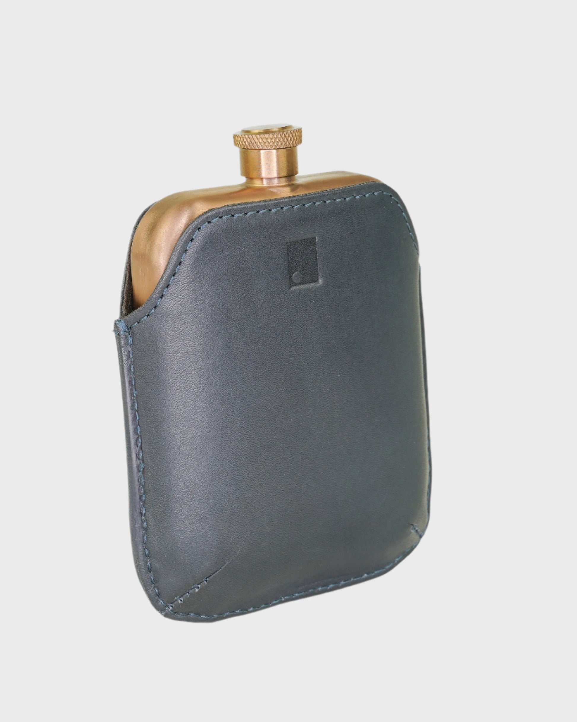 Flask with leather case on a light gray background