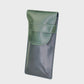 Green and navy leather case on a light gray background