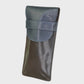 brown and navy leather case on a light gray background