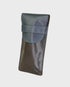 brown and navy leather case on a light gray background