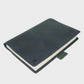 Navy leather notebook on a light gray background