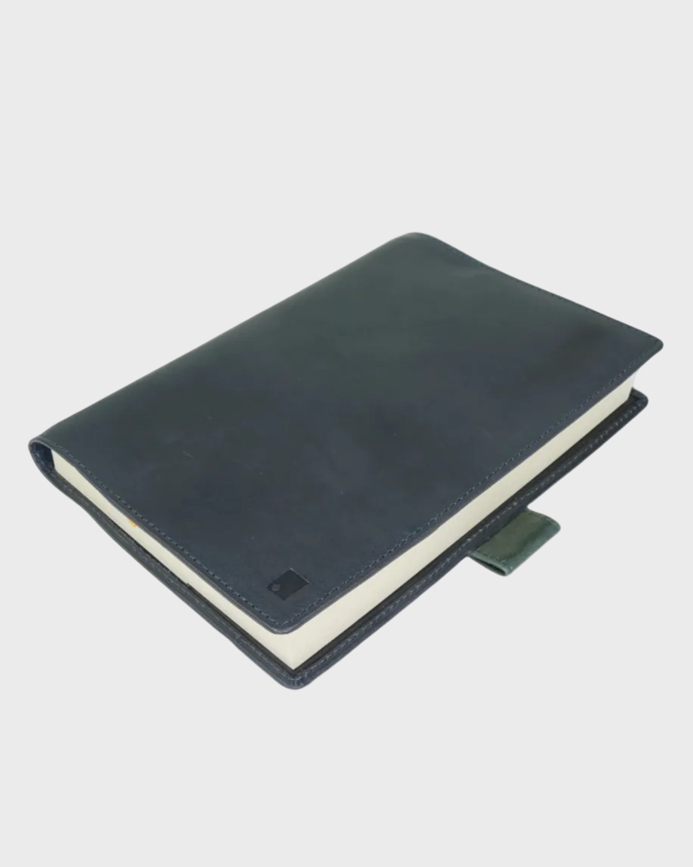 Navy leather notebook on a light gray background