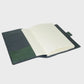 Open notebook with green and navy cover on a white background