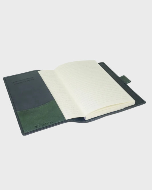Open notebook with green and navy cover on a white background