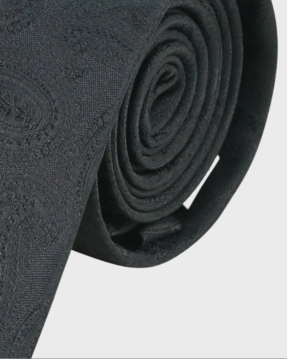 Rolled-up black tie on a white background