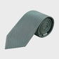 Rolled-up green tie on a light gray background