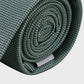 Rolled-up green tie on a light gray background
