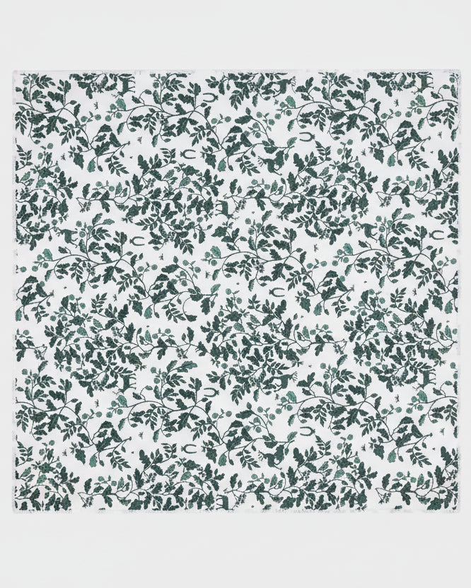 Patterned fabric with green leaves on a white background
