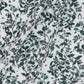 Patterned fabric with green leaves and deer on a white background