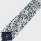 Patterned tie with a brand label on a white background