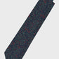 Navy tie with red and green pattern on a light gray background