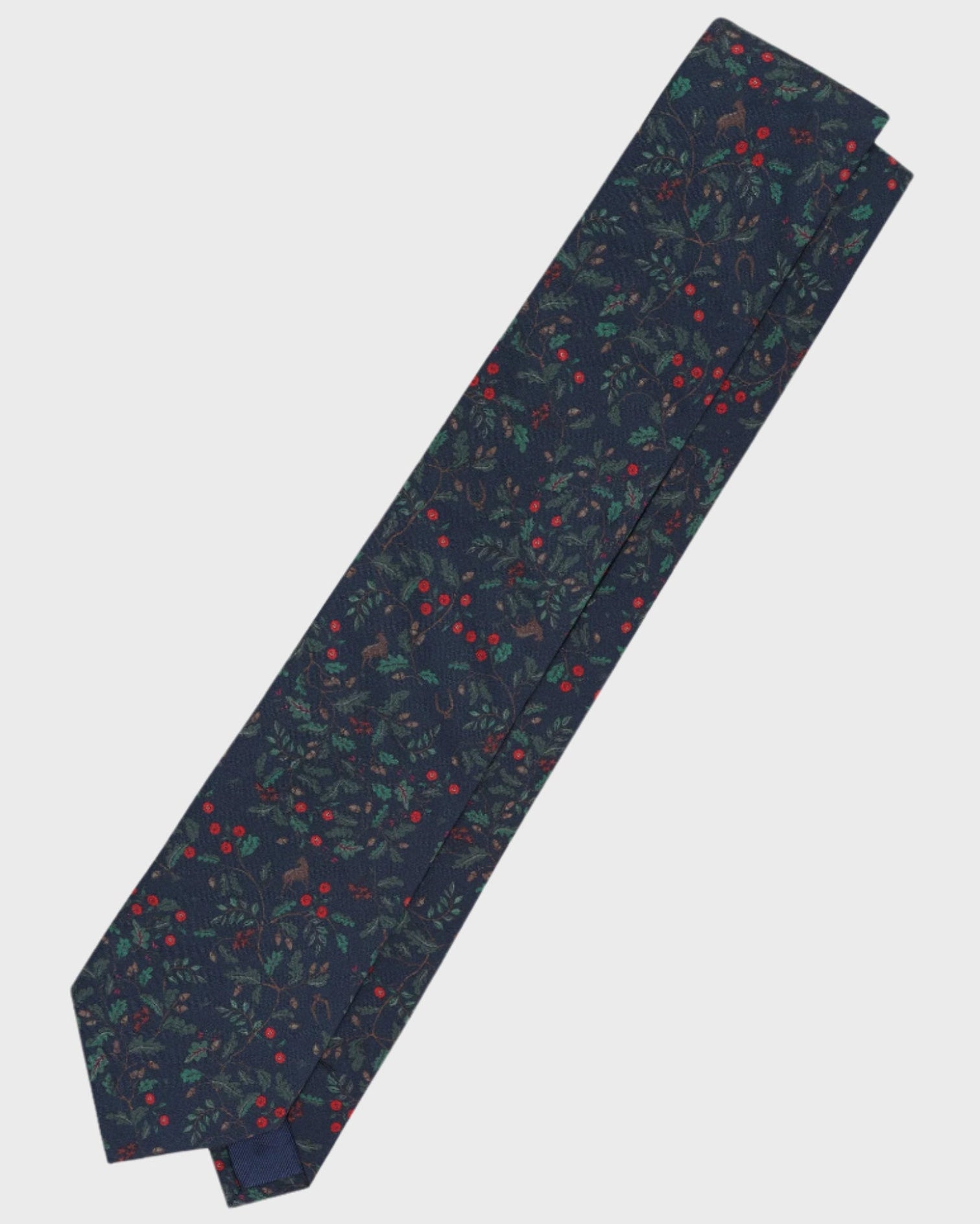 Navy tie with red and green pattern on a light gray background
