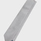 Gray tie with white polka dots on a light gray background