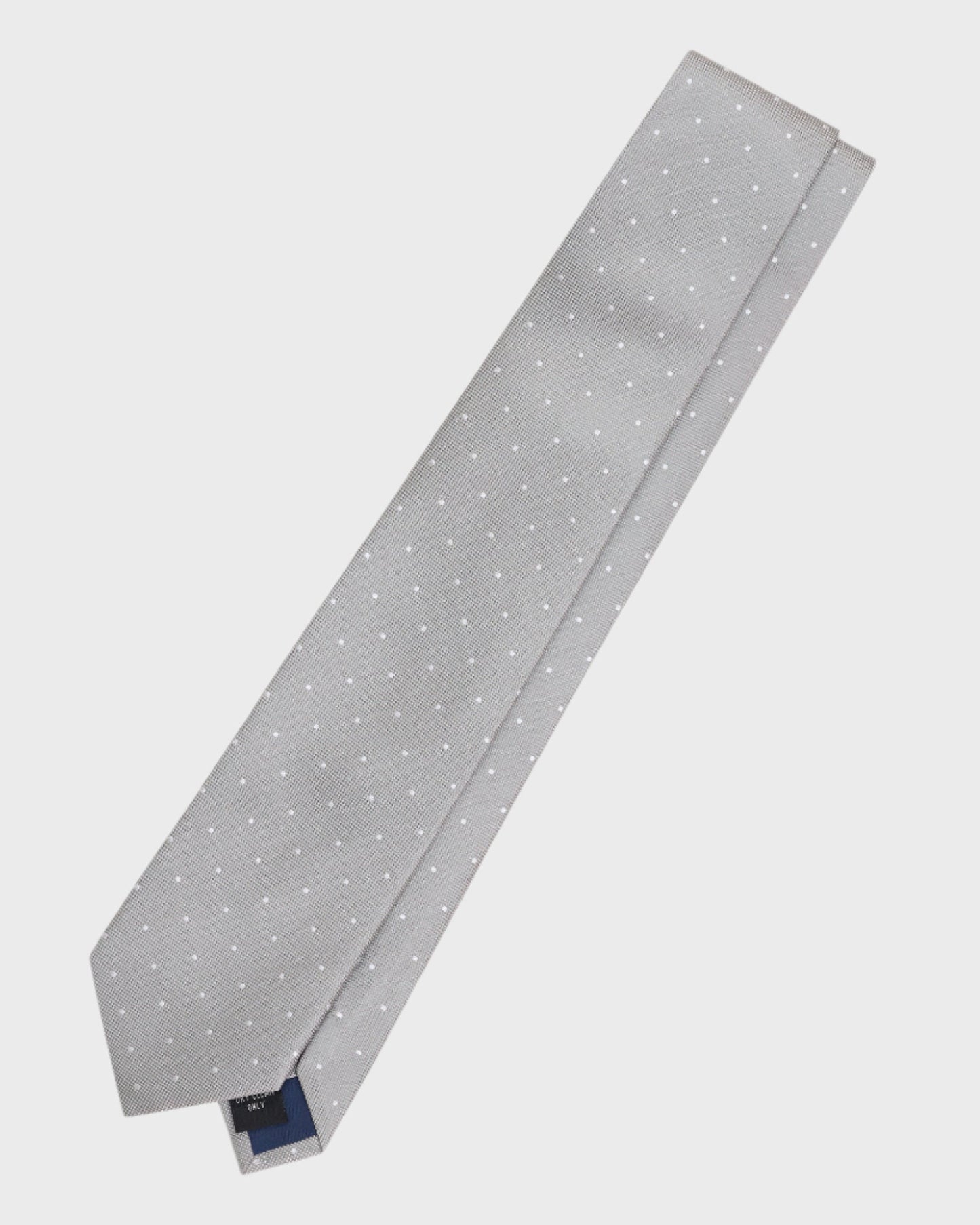Gray tie with white polka dots on a light gray background