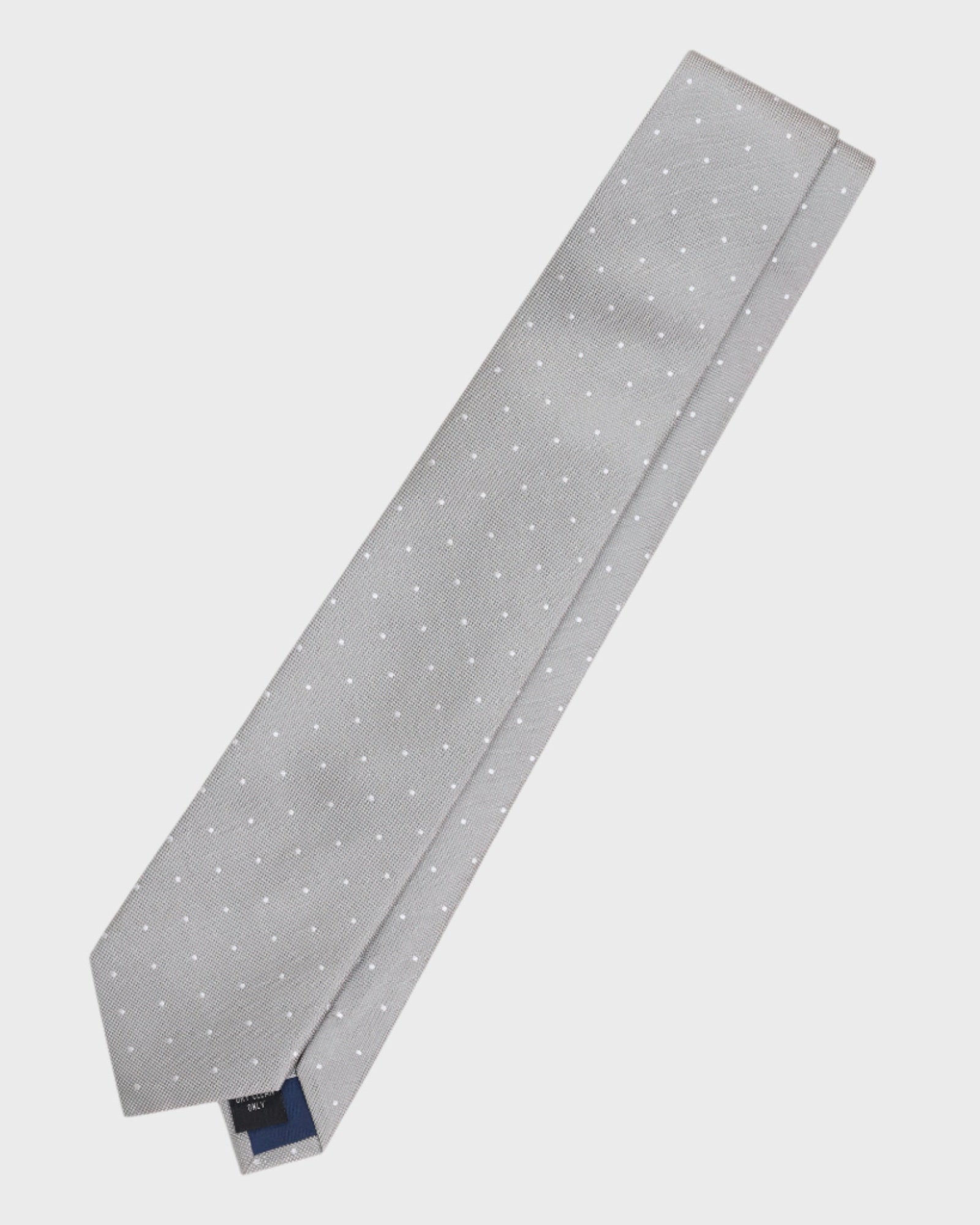 Gray tie with white polka dots on a light gray background