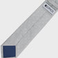 Gray tie with white polka dots and a blue patch on a light gray background