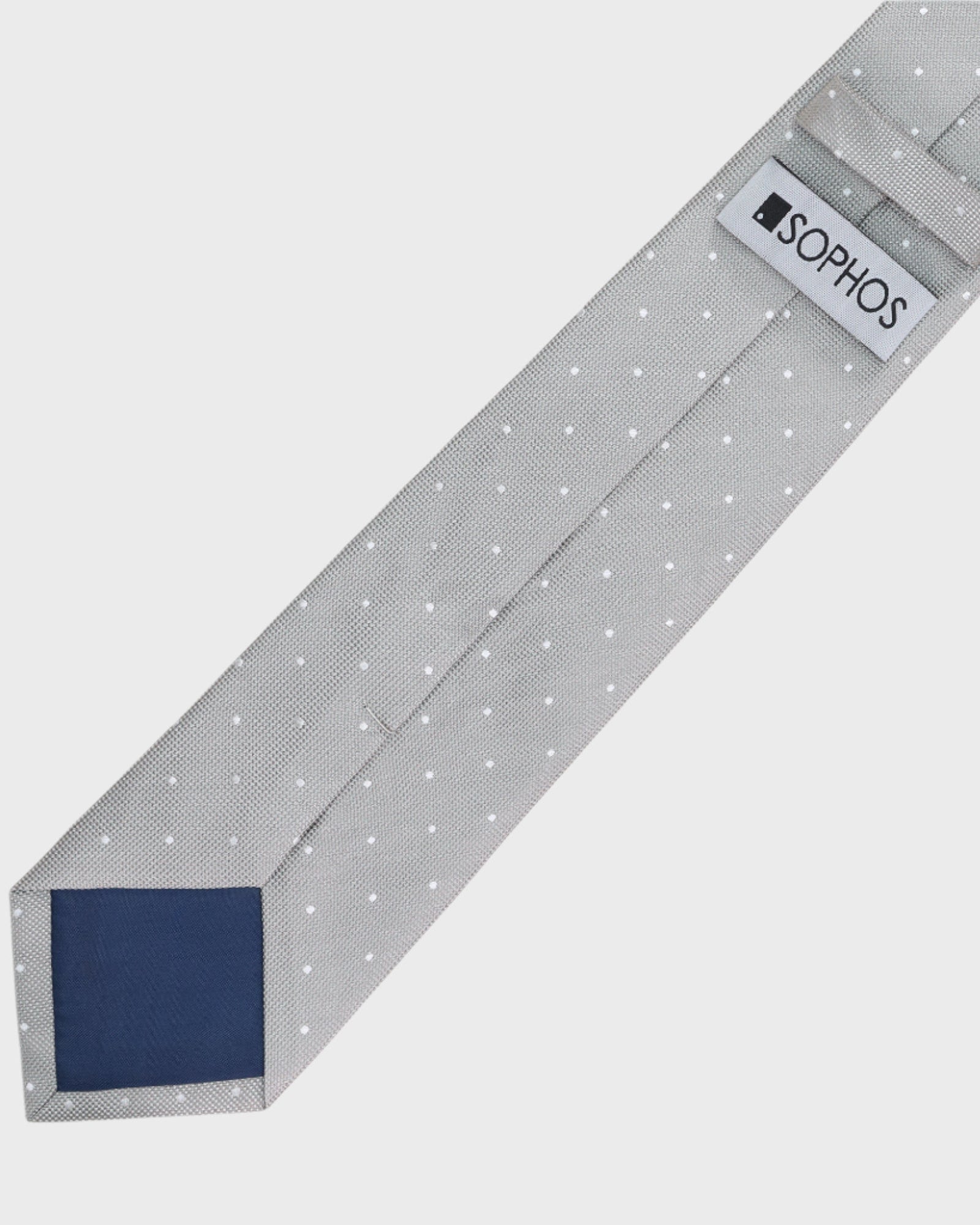 Gray tie with white polka dots and a blue patch on a light gray background