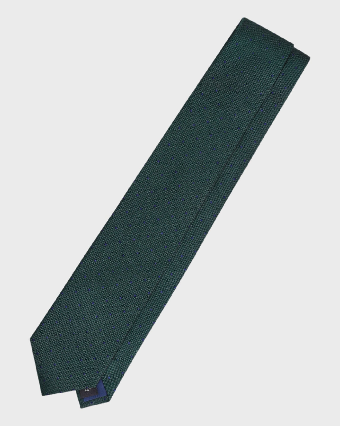 Green tie with a brand label on a light gray background