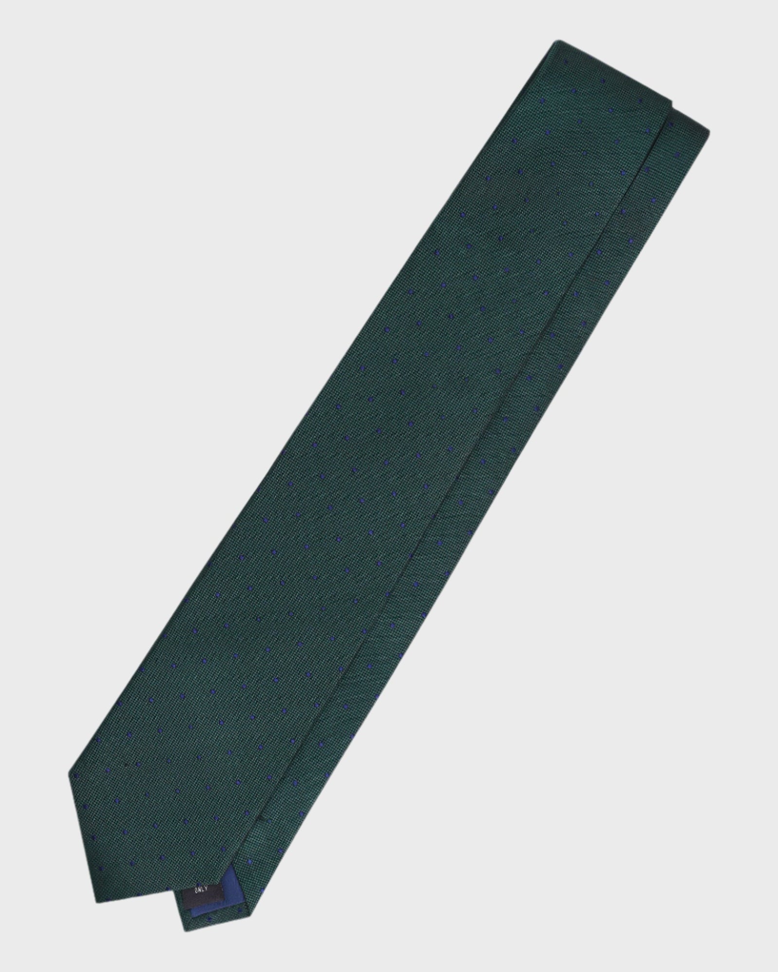Green tie with a brand label on a light gray background