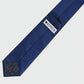 Navy blue tie with a visible brand label on a light gray background