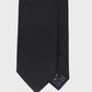 Black textured tie on a light gray background