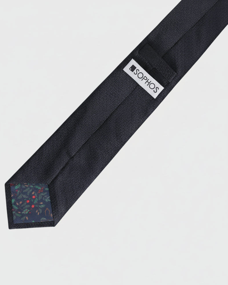 Black tie with a visible brand label on a light gray background