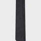 Black tie with subtle pattern on a light gray background