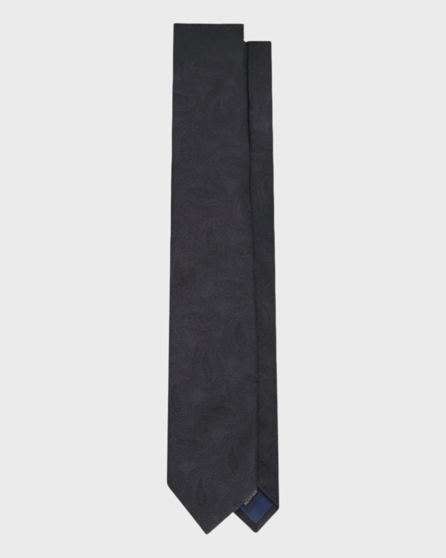 Black tie with subtle pattern on a light gray background