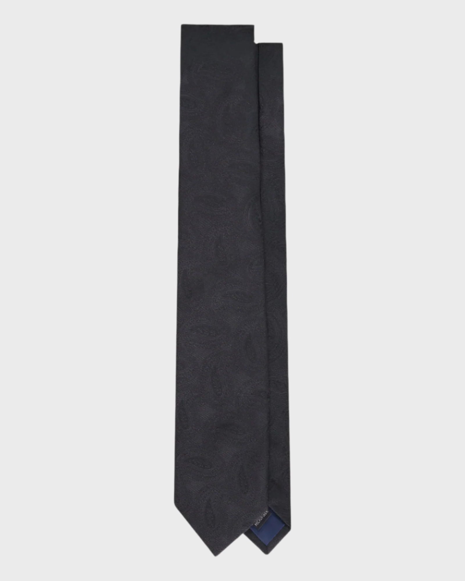 Black tie with subtle pattern on a light gray background