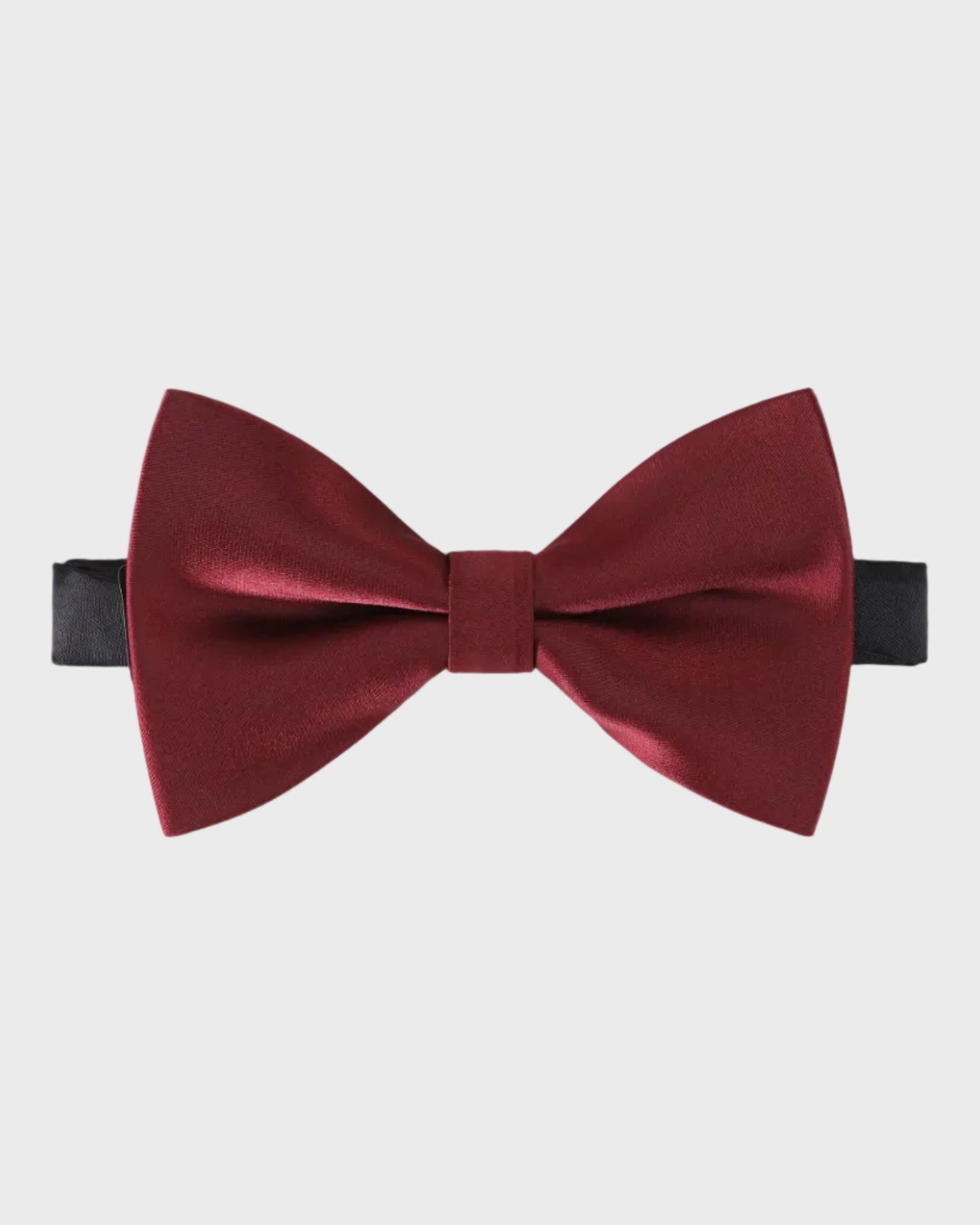 Burgundy bow tie on a light gray background