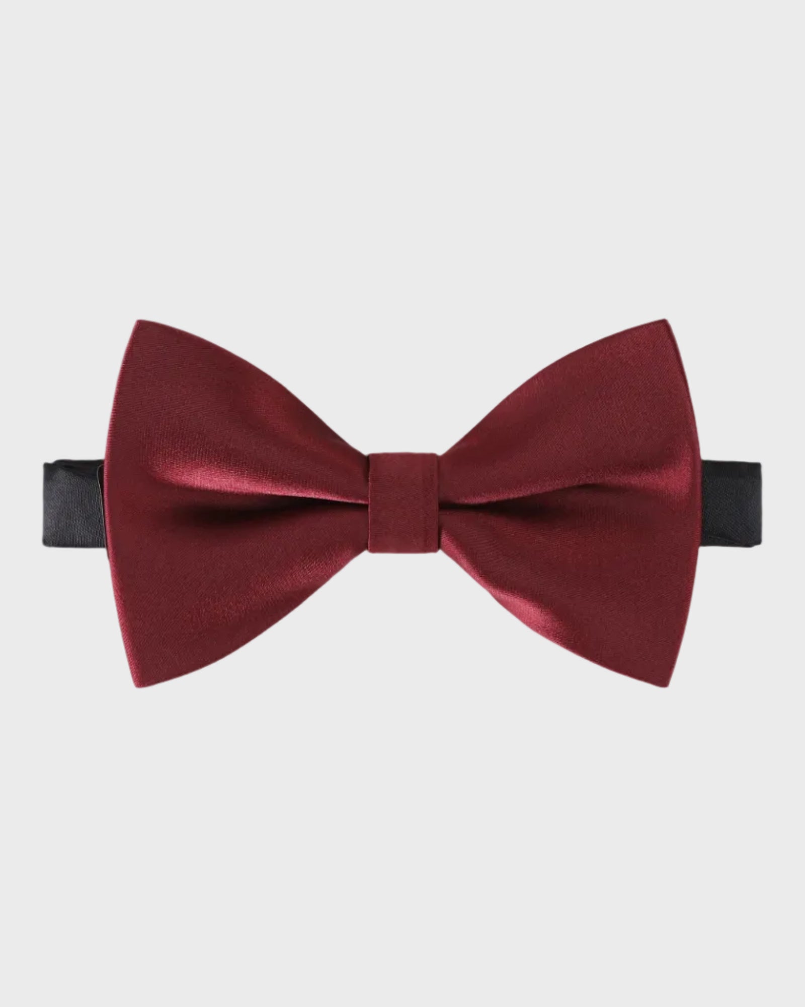 Burgundy bow tie on a light gray background