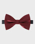 Burgundy bow tie on a light gray background