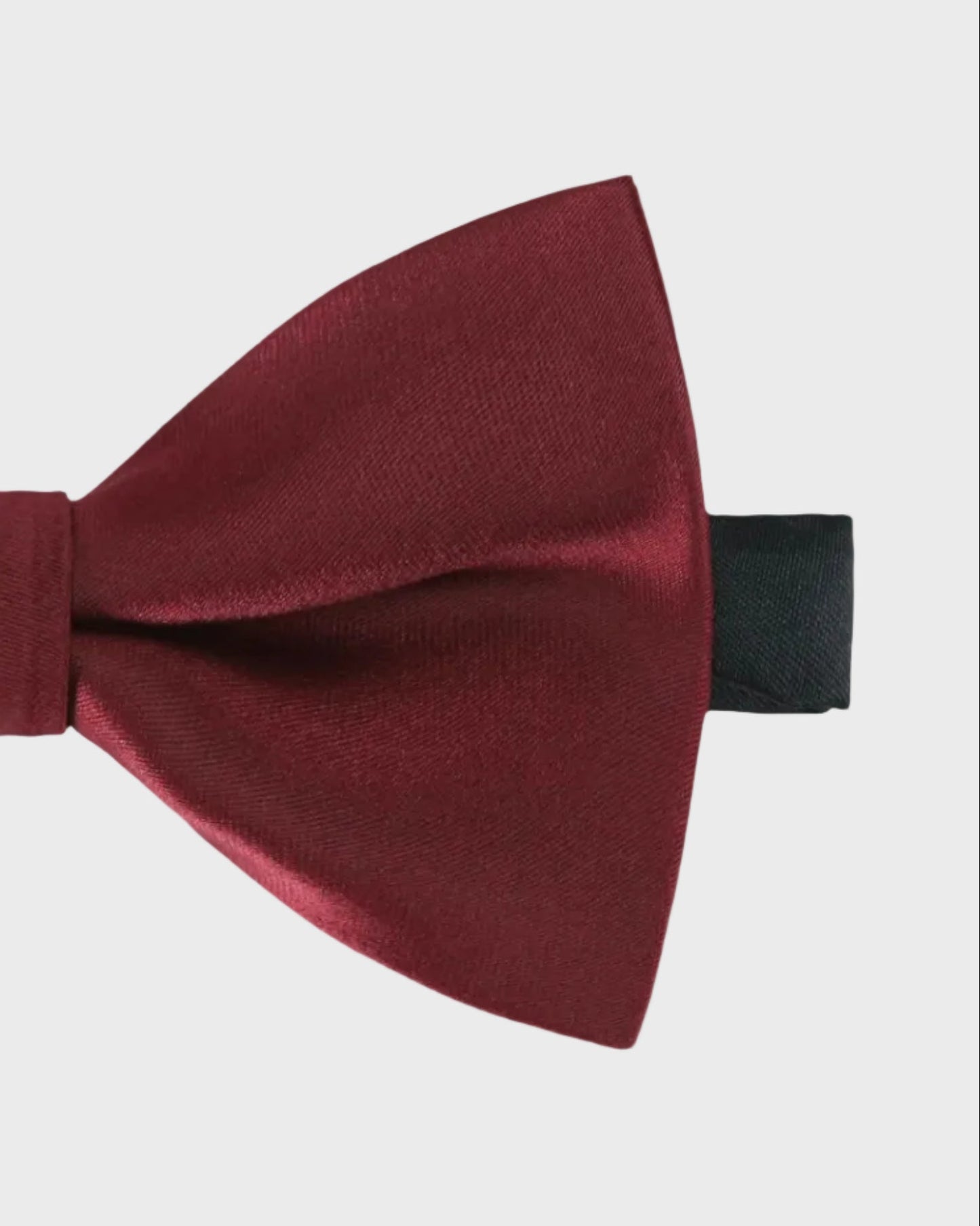 Burgundy bow tie on a light gray background