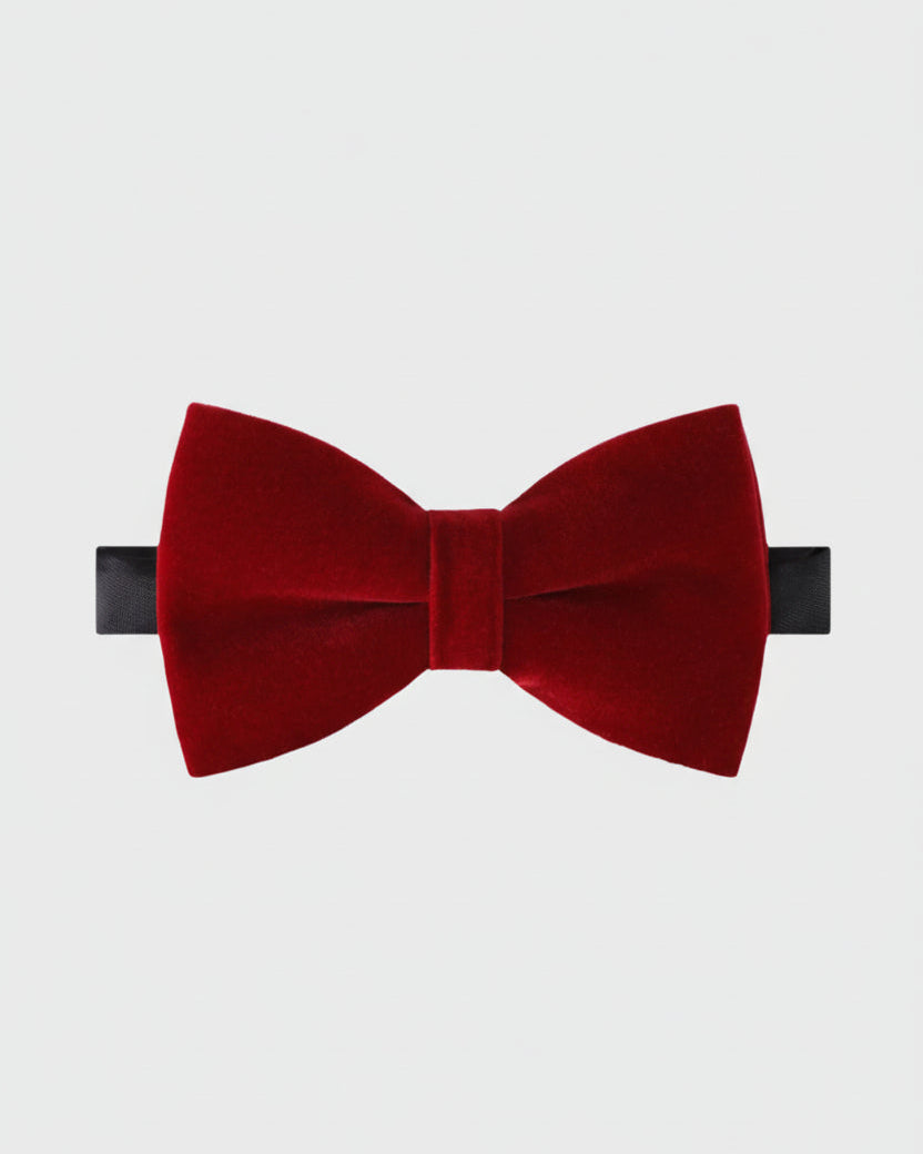 Red velvet bow tie on a light gray background