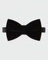 Black bow tie on a light gray background
