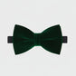 Green velvet bow tie on a light gray background