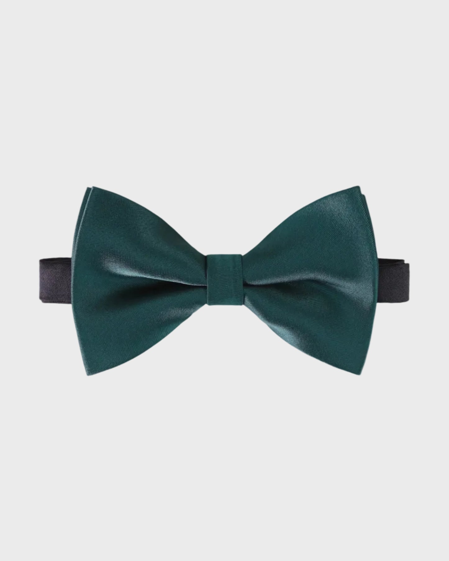 Green bow tie on a light gray background