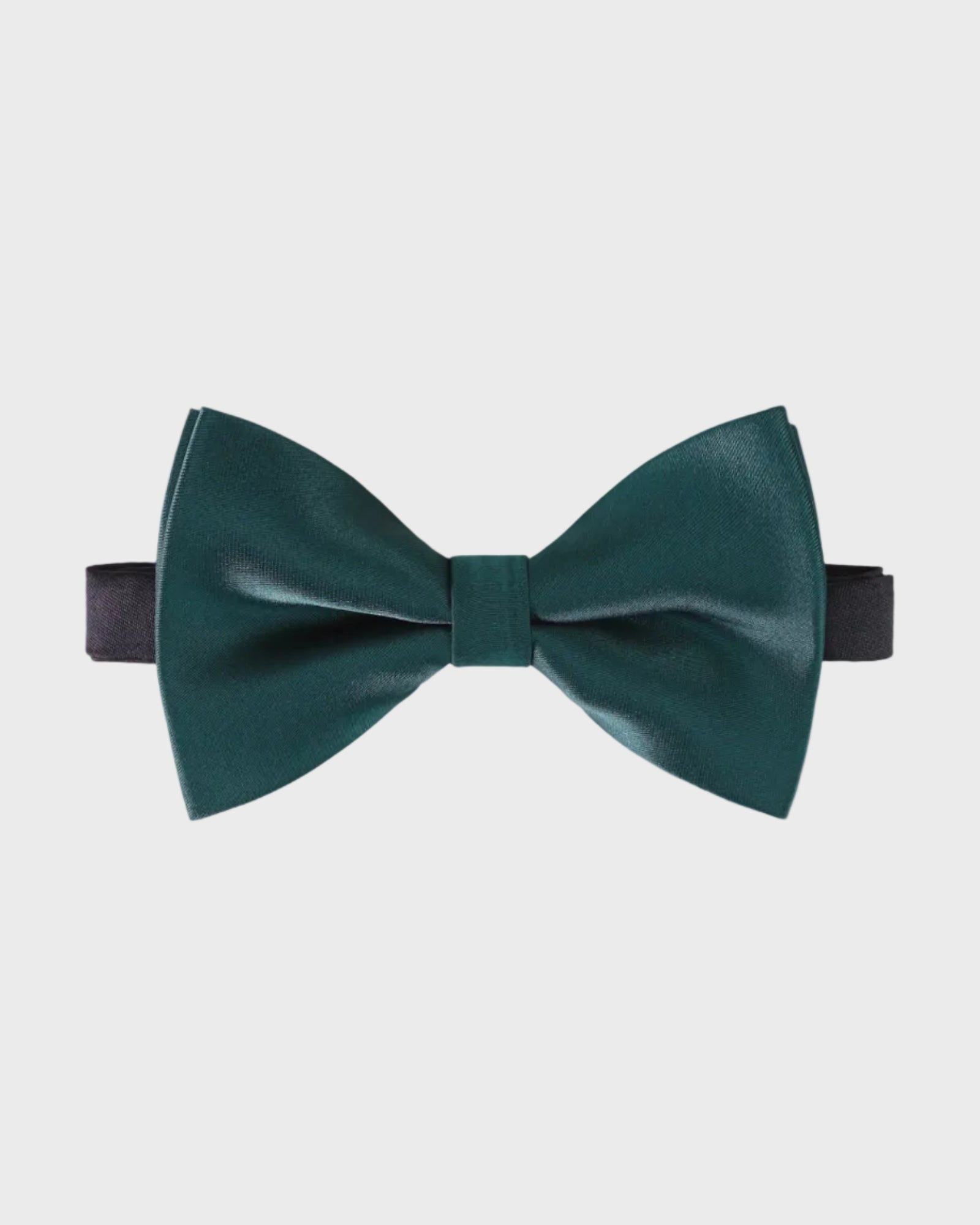 Green bow tie on a light gray background