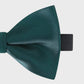 Green bow tie on a light gray background