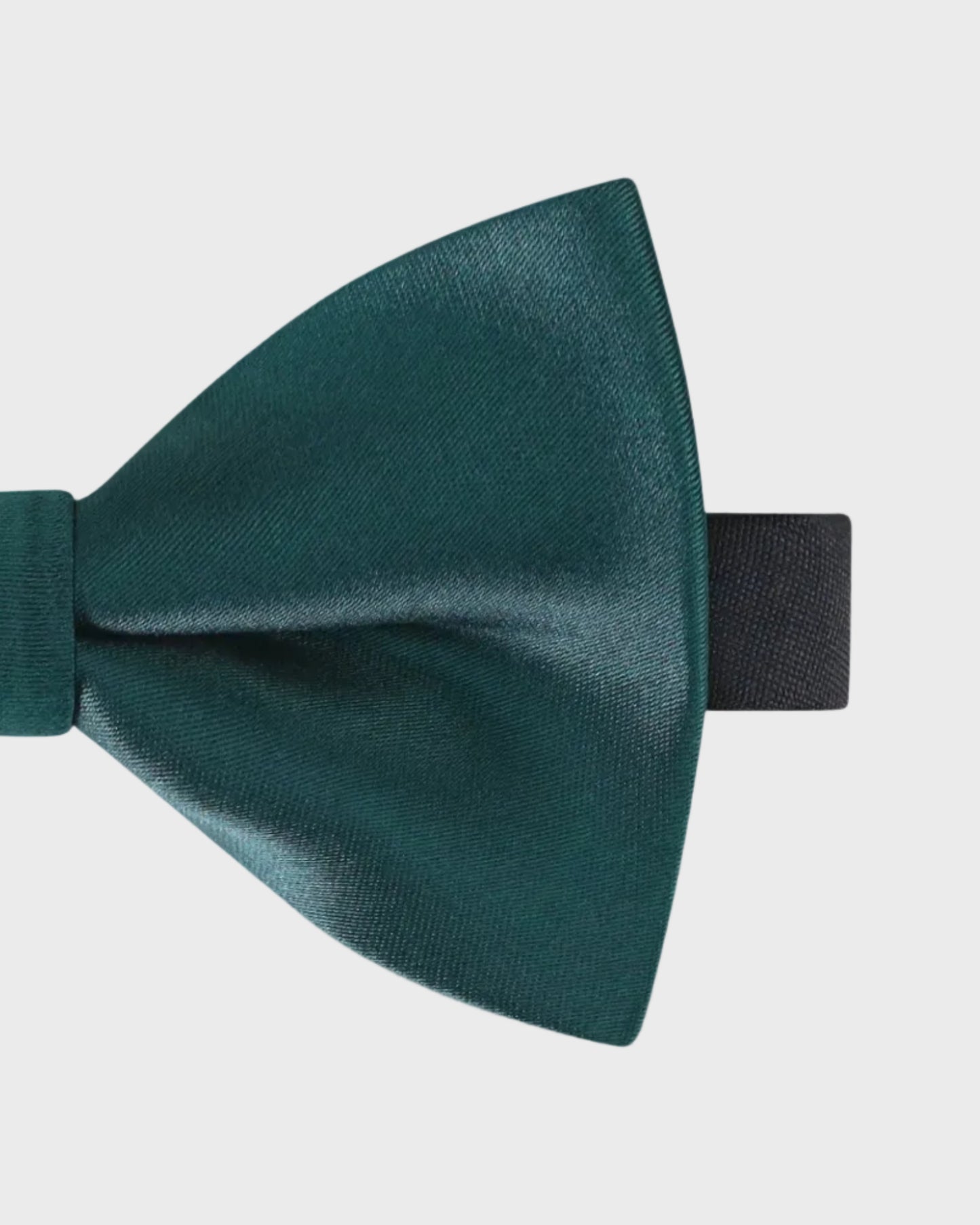 Green bow tie on a light gray background