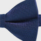 Blue textured bow tie on a light gray background
