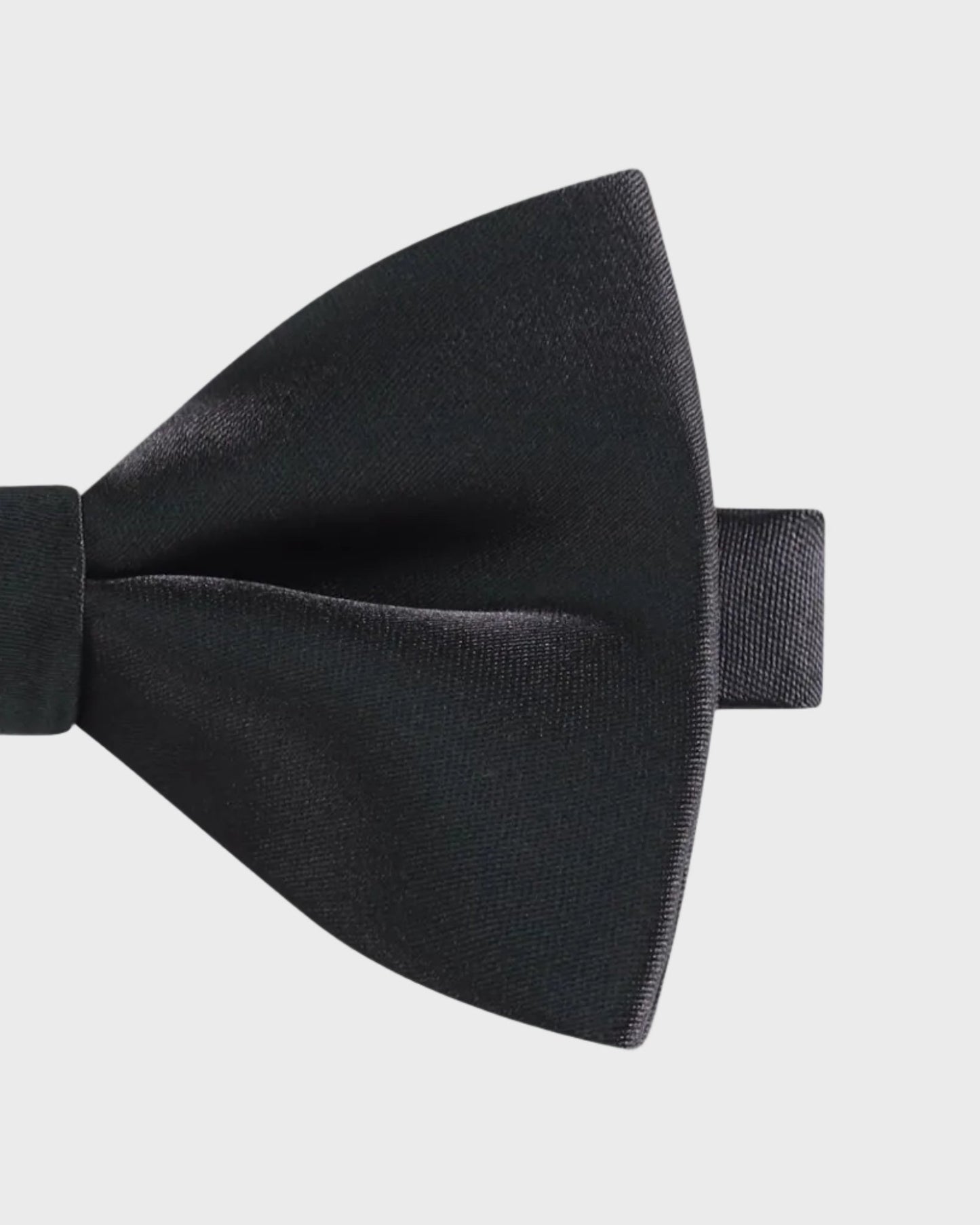 Black bow tie on a light gray background